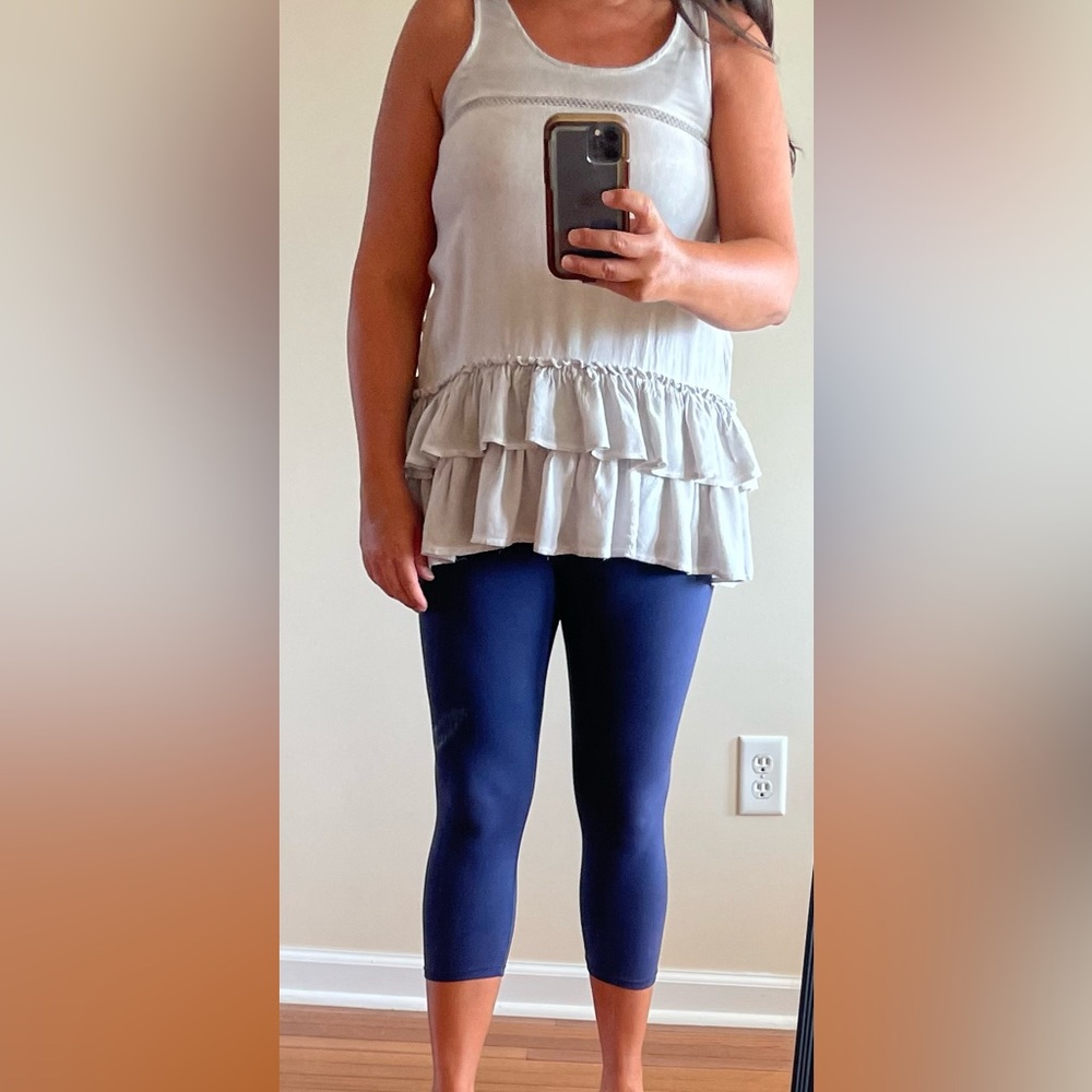 entro women’s size small sleeveless top with ruffles. Bum coverage.